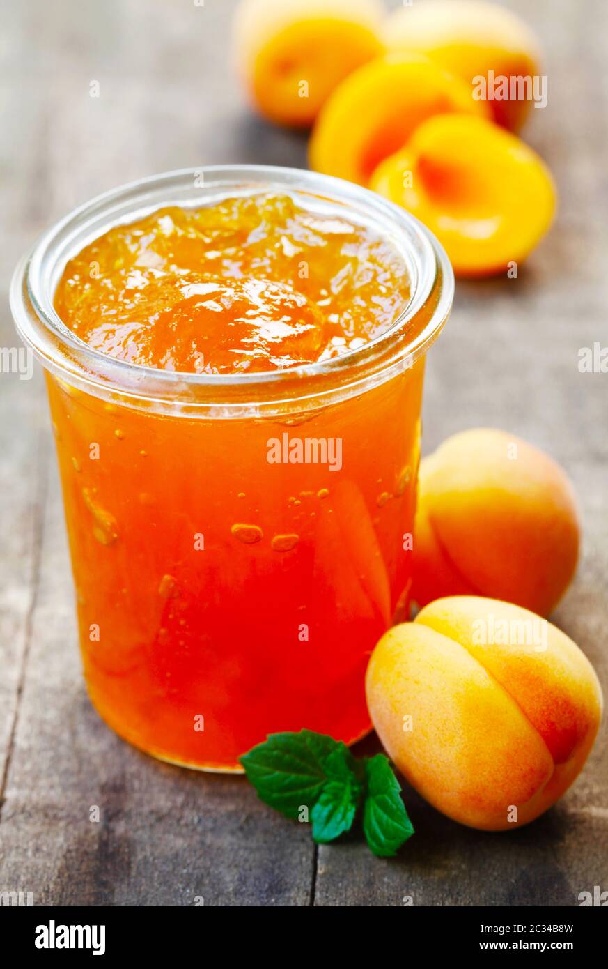 A Jar Of Apricot Jam On A Wooden Background Stock Photo