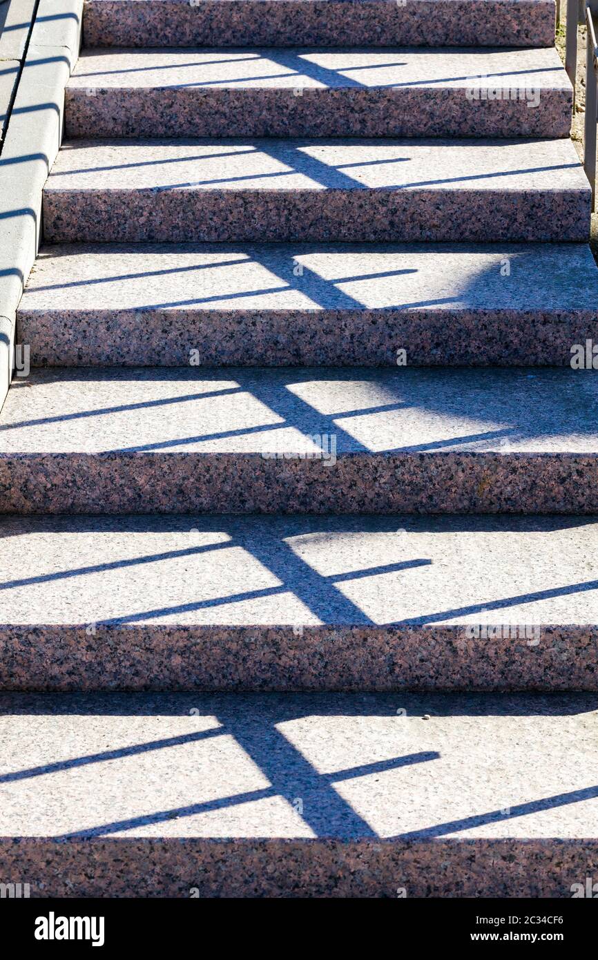 part and close-up of concrete stairs on the street, a real new design with shadows from the railing, Sunny day Stock Photo