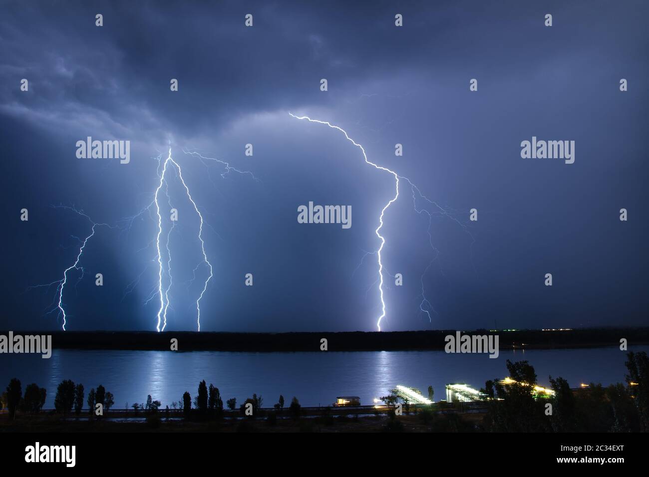 Lightning strike in the night sky above the river Stock Photo - Alamy