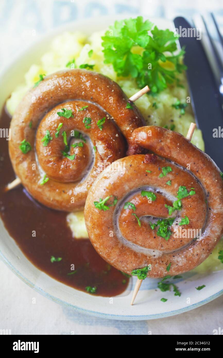 Spiral-Shaped Bratwurst With Mashed Potatoes Stock Photo