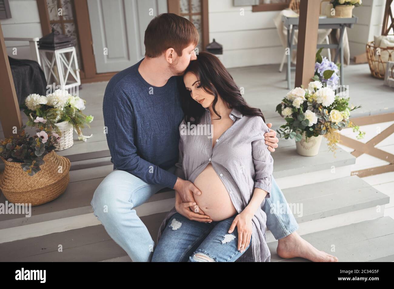 Pregnancy concept - happy man hugging his beautiful pregnant wife at ...