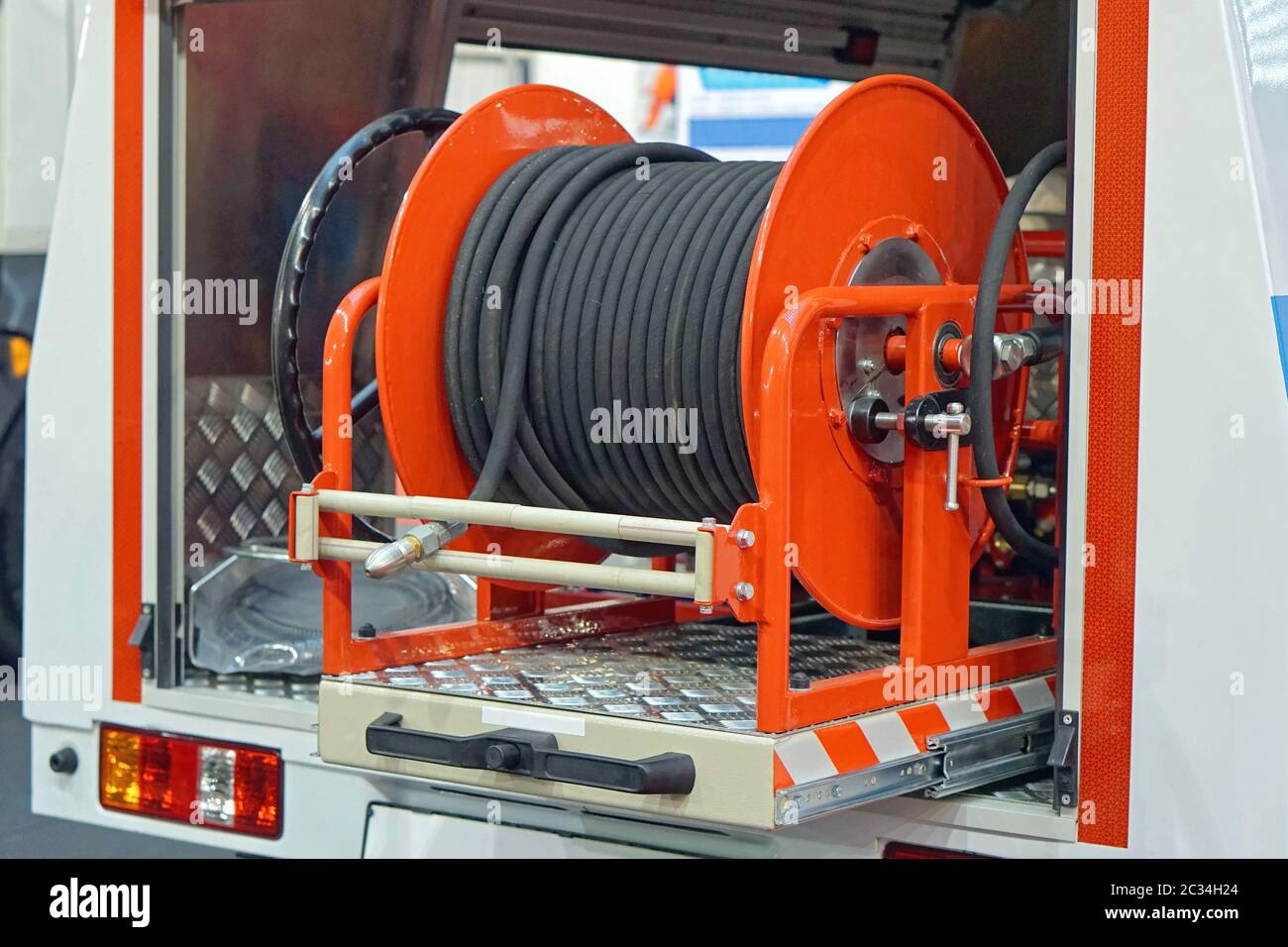 Fire hose coil at truck engine Stock Photo Alamy