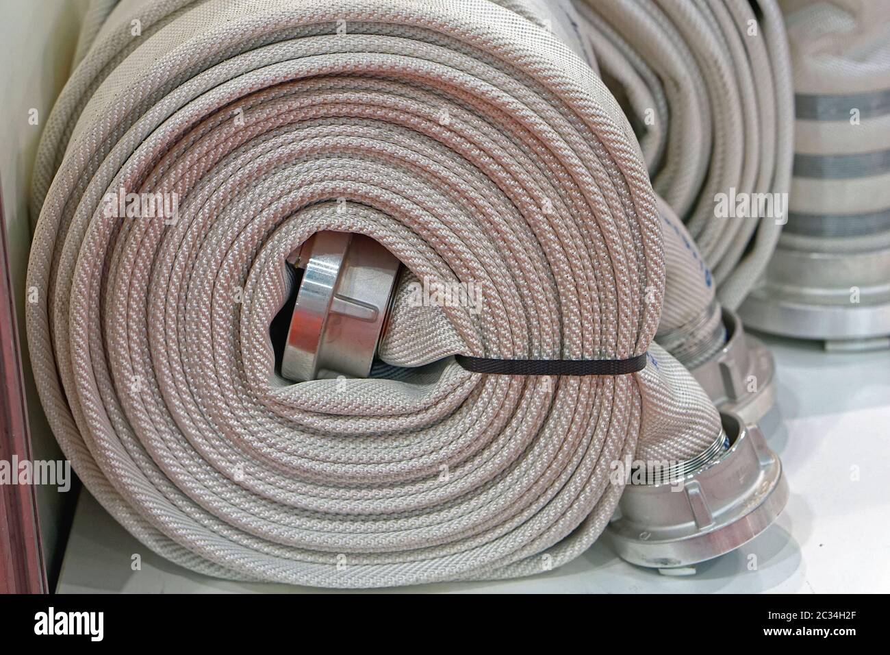 High pressure fire hose in coil Stock Photo Alamy