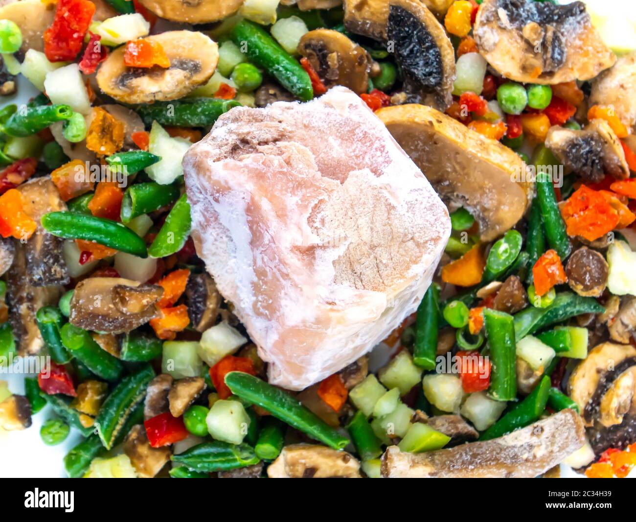 Frozen vegetables and meat on a white background with place for text. Food photo. Vegetable salad. Background image. Free place. Stock Photo