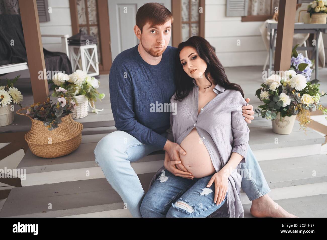 Pregnancy concept - happy man hugging his beautiful pregnant wife at ...