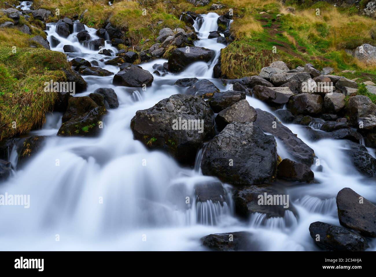 Stream flowing from the Bjarnafoss waterfall Stock Photo