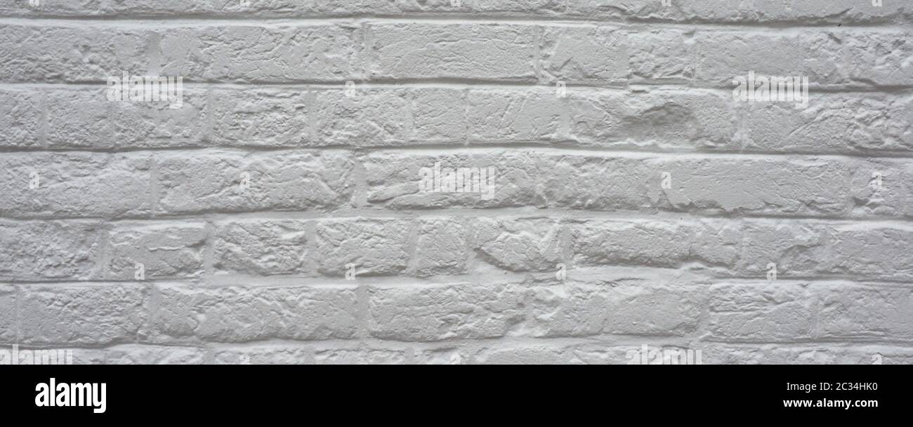 wide White brick wall useful as a background Stock Photo - Alamy