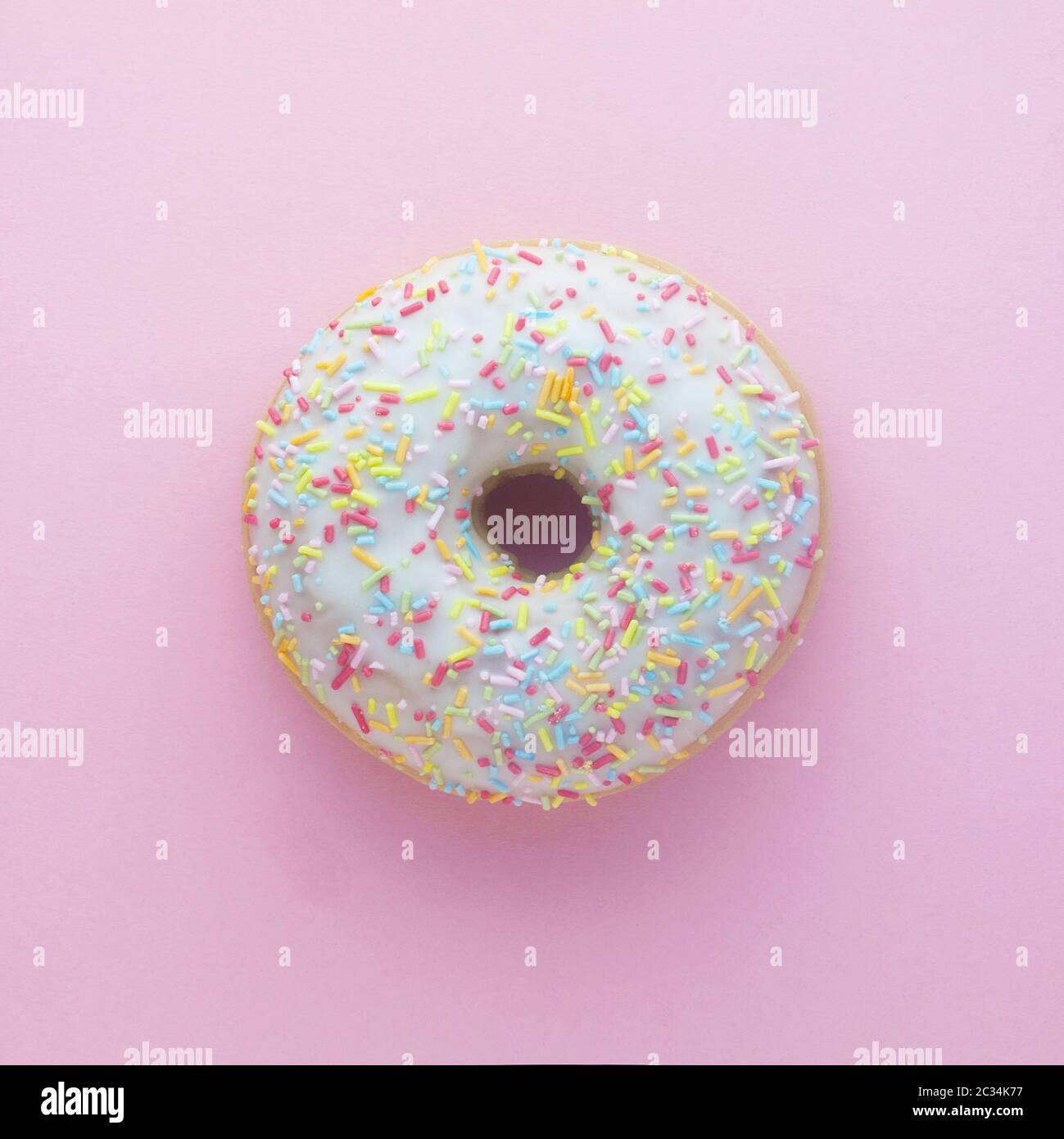 Top View Of A Doughnut On A Pink Background Stock Photo