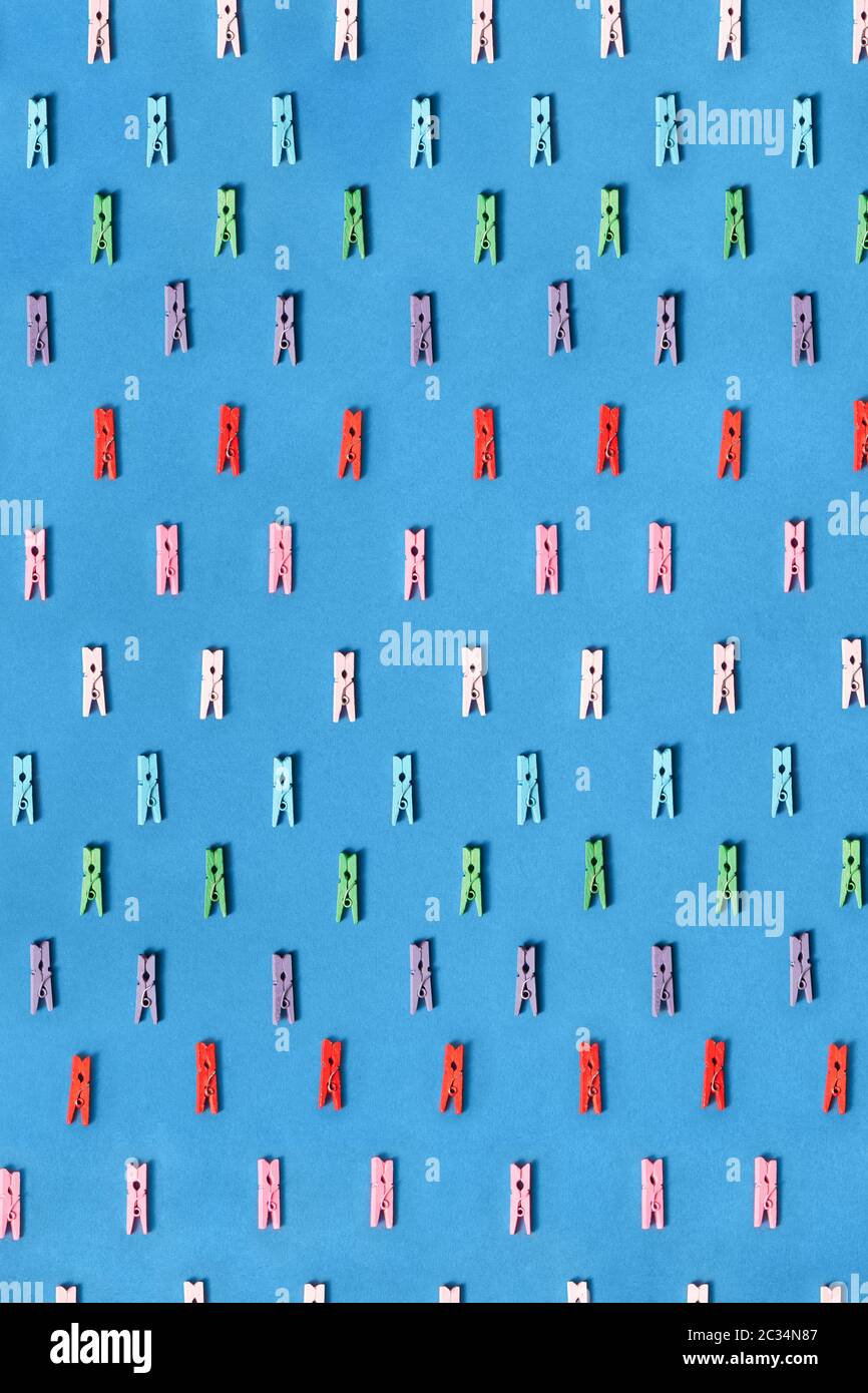 Colored clothespins pattern on a blue. Stock Photo