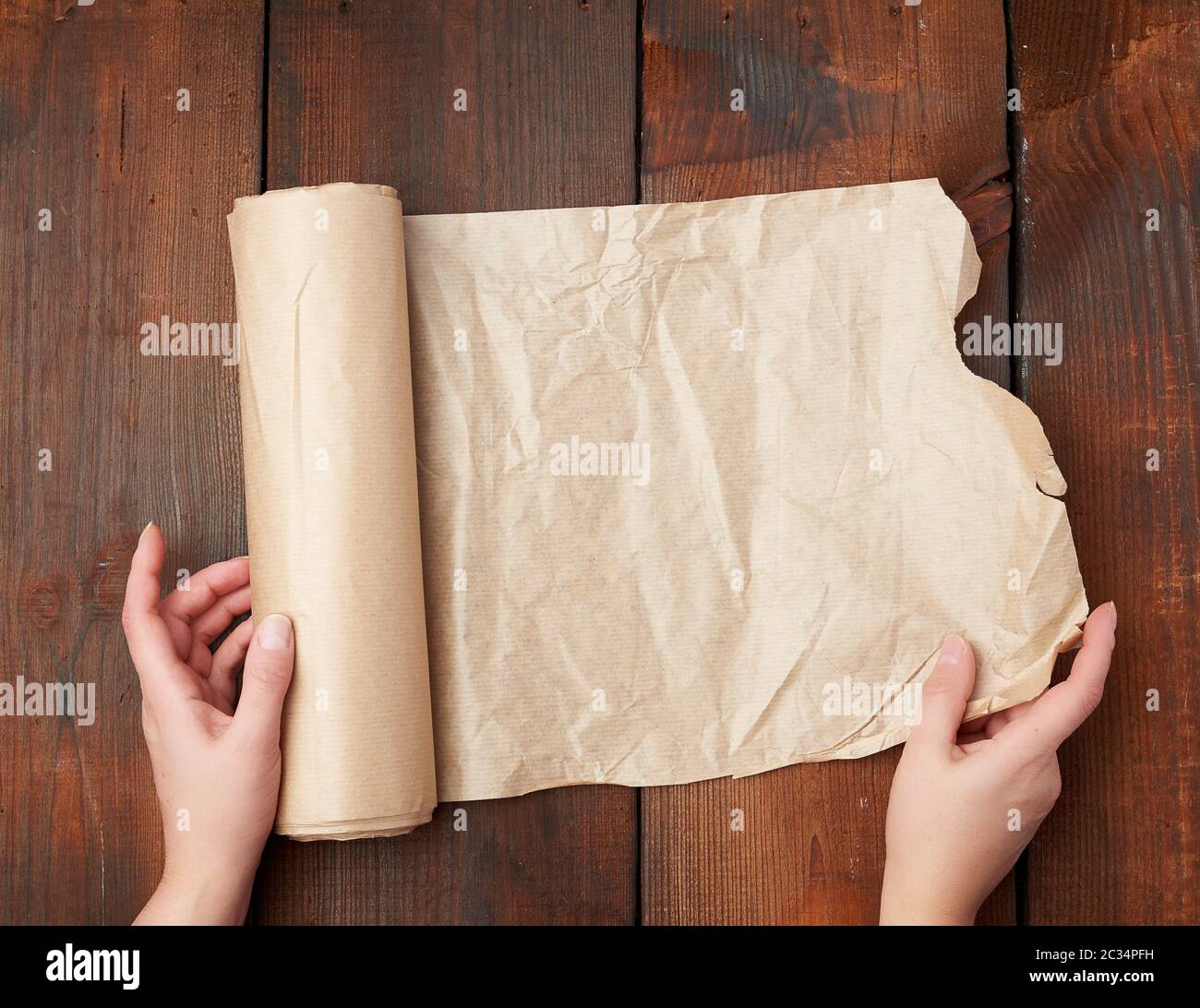 rolls of brown parchment paper on a wooden surface, top view Stock Photo