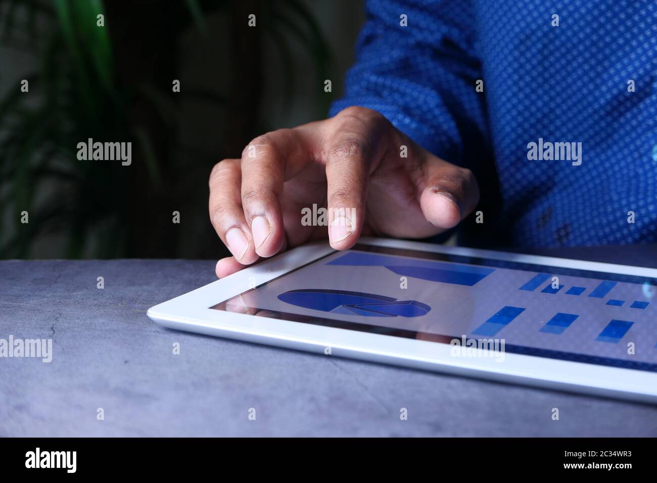 man's hand working on digital tablet at office desk, using self created ...