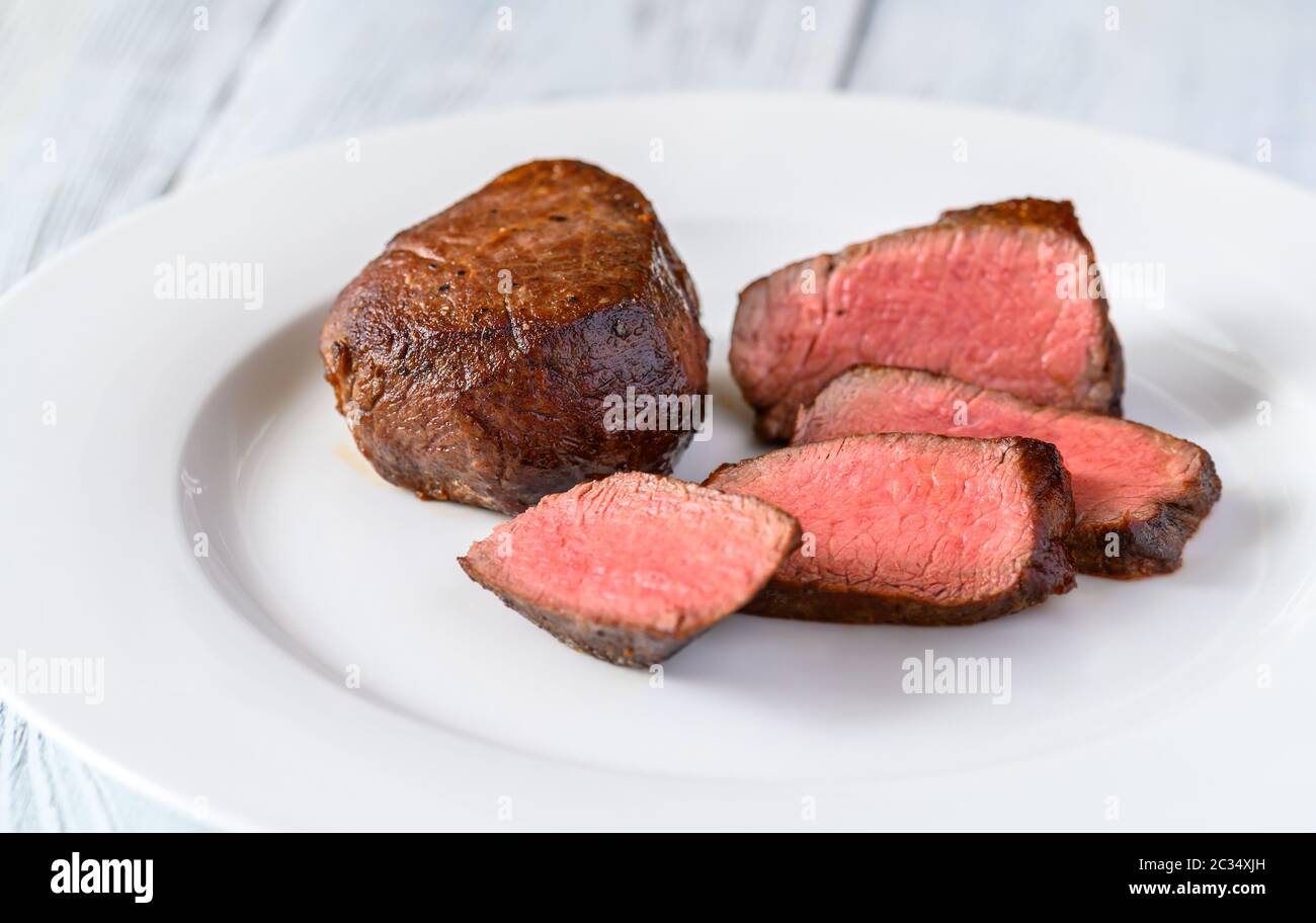 Filet mignon on the plate: cross section Stock Photo - Alamy