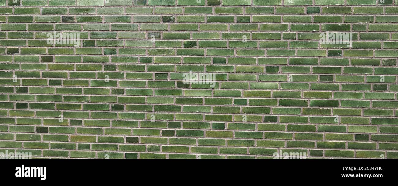 green brick wall useful as a background Stock Photo - Alamy