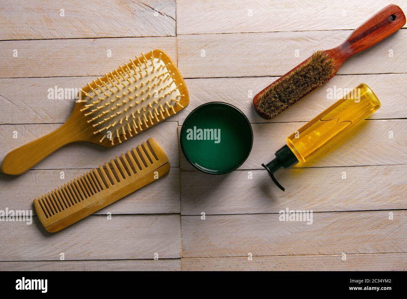 Hair gel and comb for haircut stand on a white table. Hairdressing