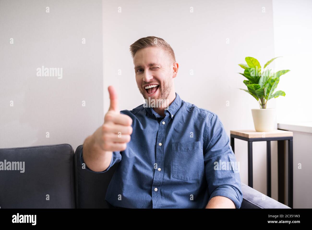 Happy handsome man winking hi-res stock photography and images - Alamy