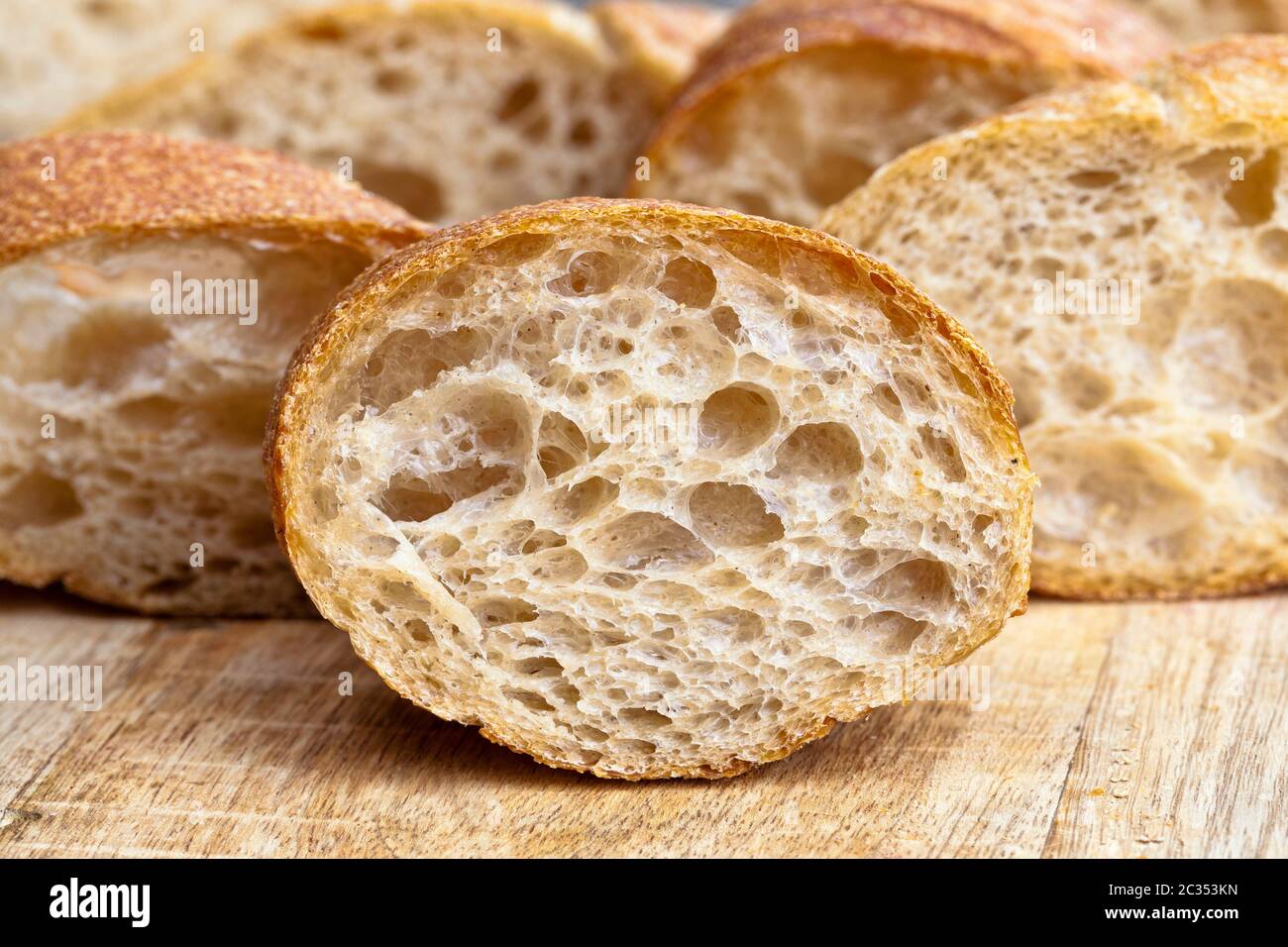 long fresh flavored bread with a crisp crust and soft fresh flesh, food close up Stock Photo