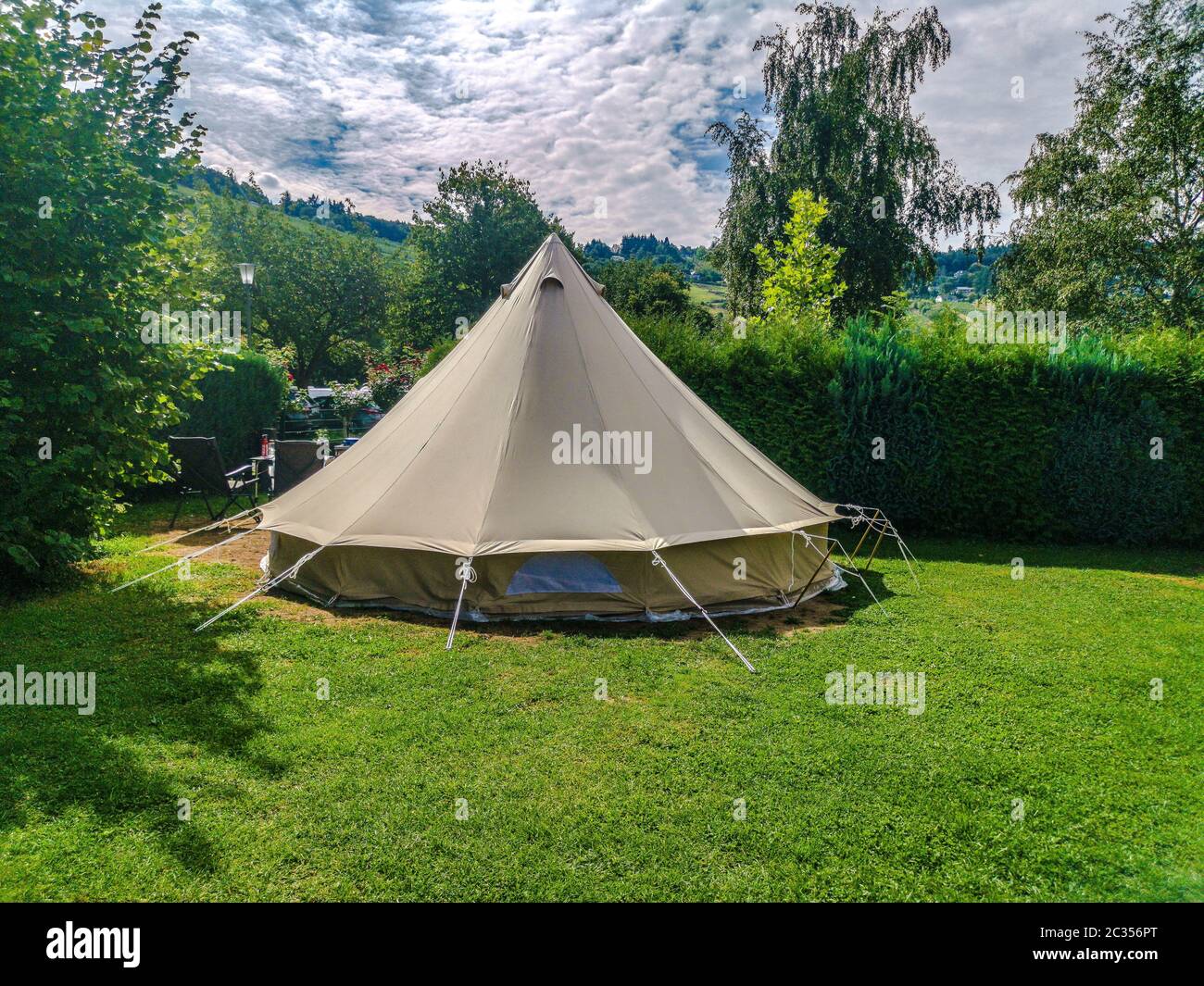 Traditional indian teepee tent on camp site in germany on green grass Stock Photo