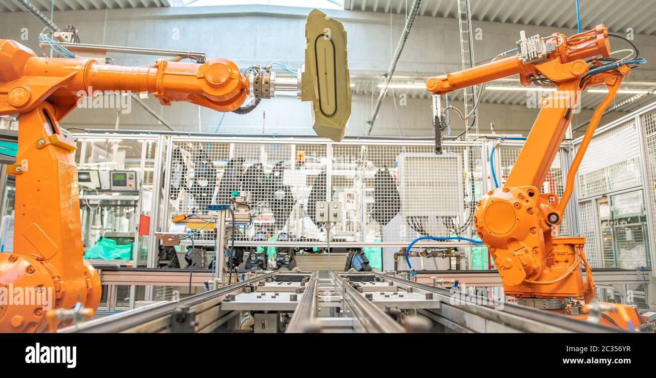 orange robot arms on the production line. controlled by a computer with  artificial intelligence Stock Photo - Alamy