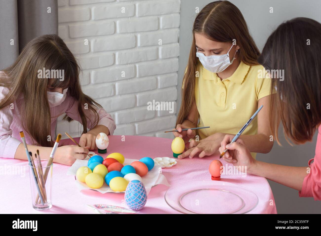 Quarantined sick family paints eggs for Easter Stock Photo