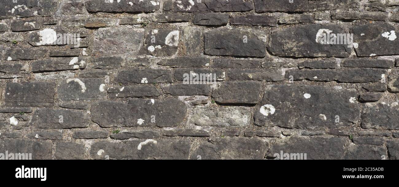 wide grey stone wall useful as a background Stock Photo - Alamy