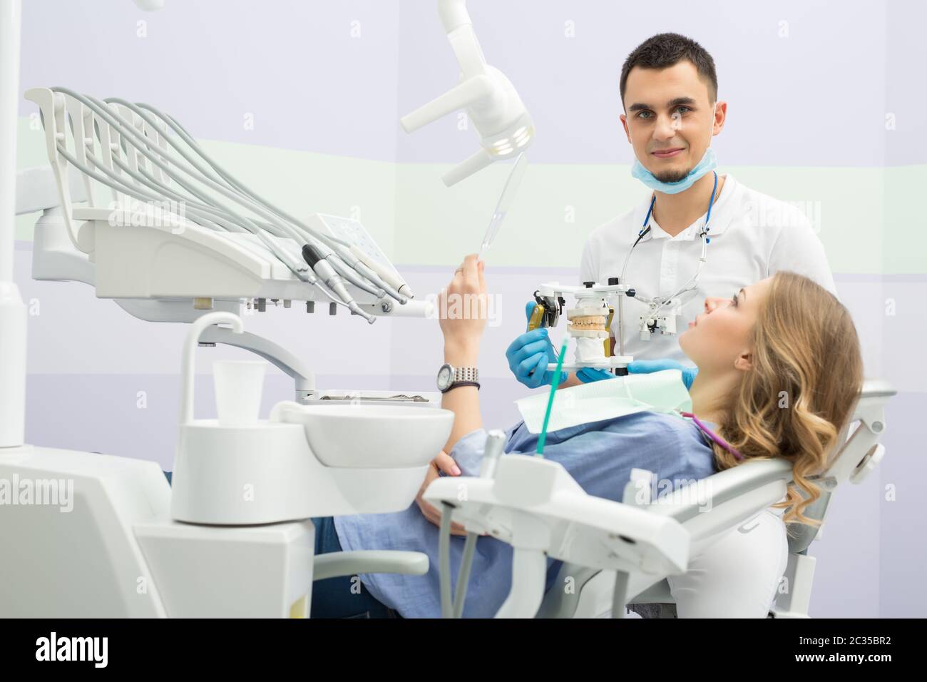 Modern dental clinic, young dentist working Stock Photo Alamy