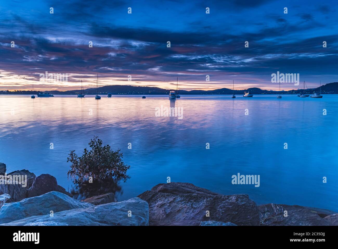 Colourful Clouds and Sunrise from Koolewong Waterfront on the Central Coast, NSW, Australia. Stock Photo