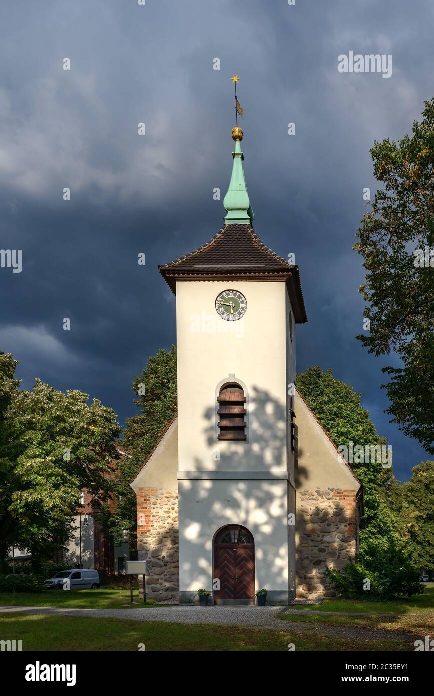 Thunderclouds over the  village church in Berlin-Reinickendorf Stock Photo