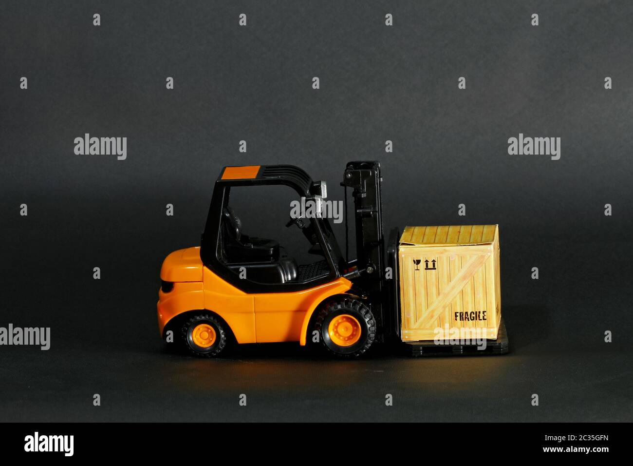 Small forklift vehicle with fragile transportation crate Stock Photo