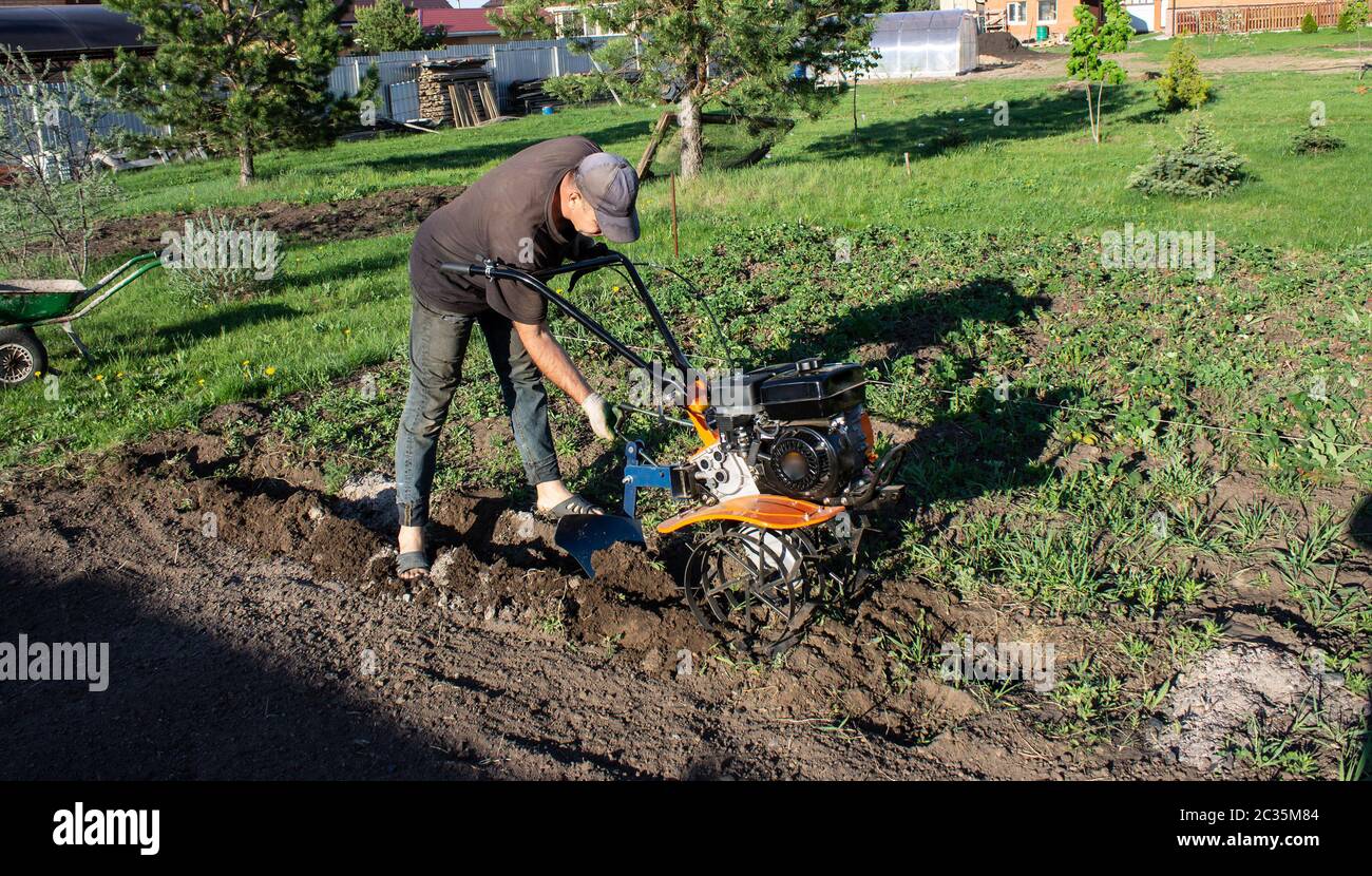 a man plowing a field cultivator, land Stock Photo Alamy