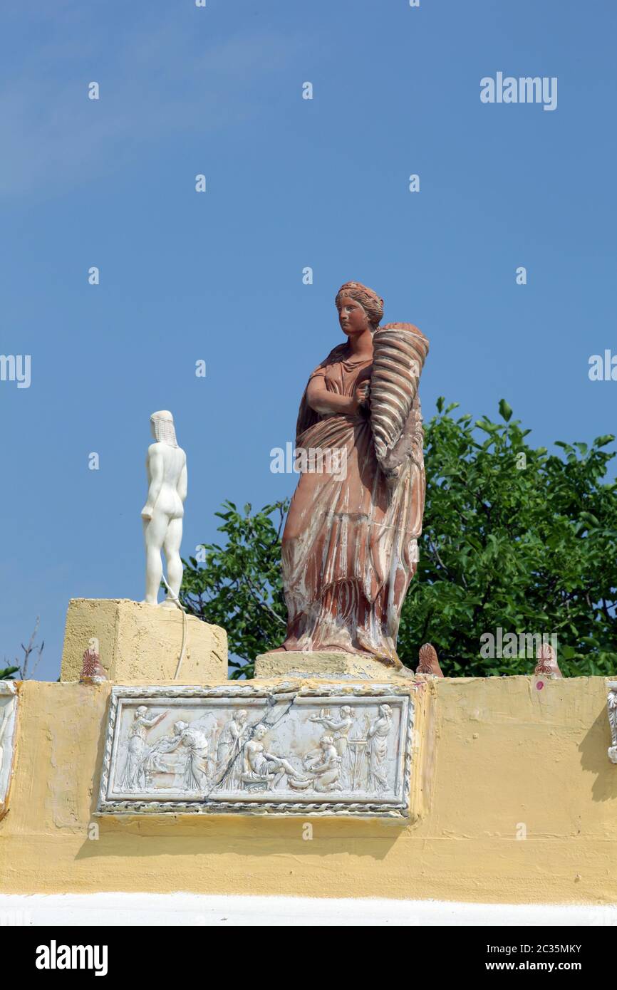 Sculptures on the roof of a house in a traditional Greek village of Zia