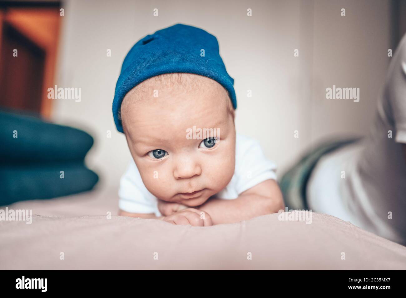 Cute little baby boy lying on pink blanket at bedroom. Newborn. Baby