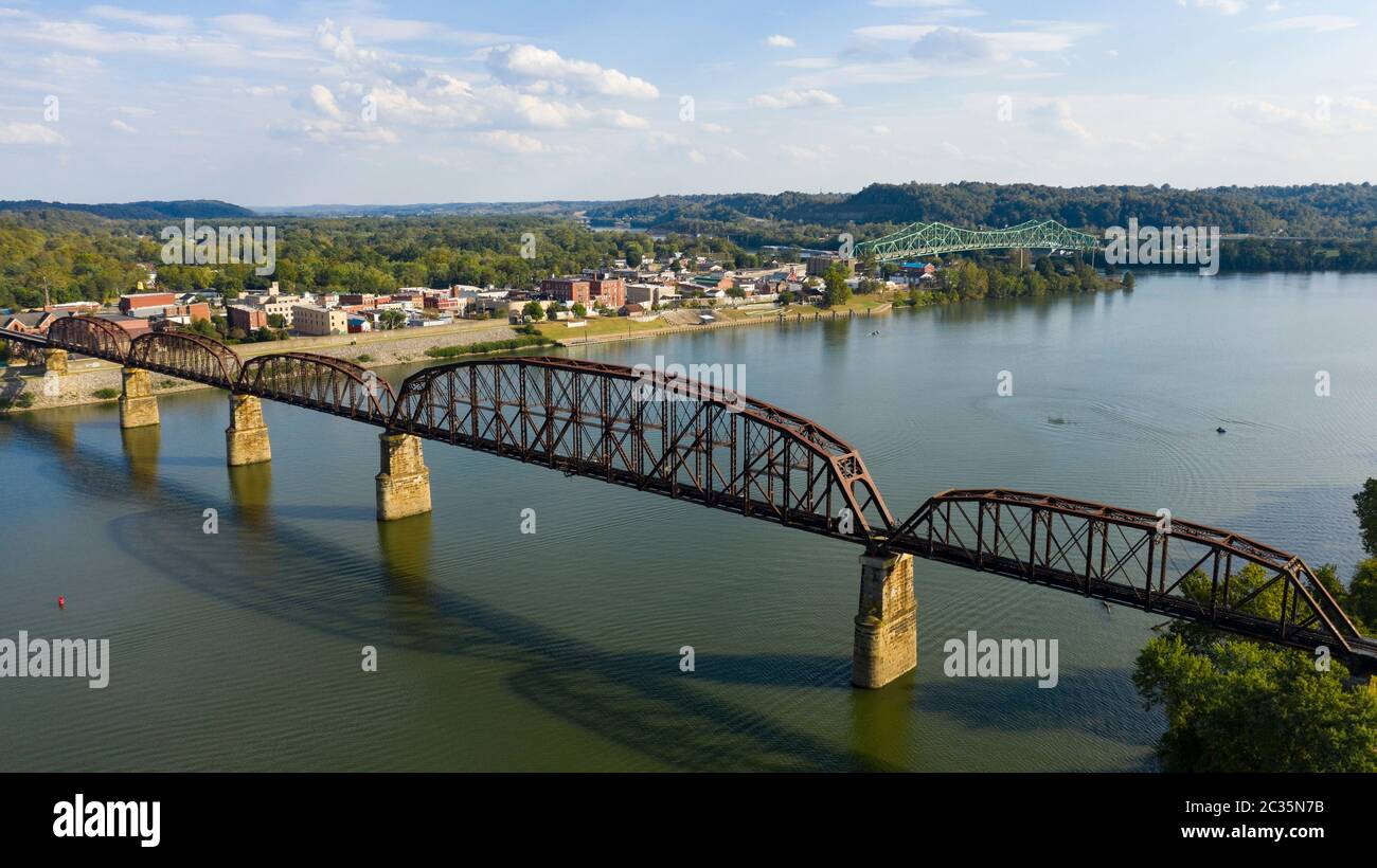 Looking across the Ohio River into downtown Point Pleasant over an old railroad bridge trestle Stock Photo