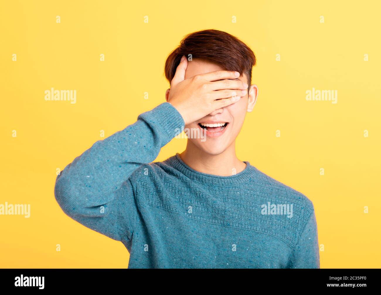 young man covering his eyes with hand Stock Photo Alamy