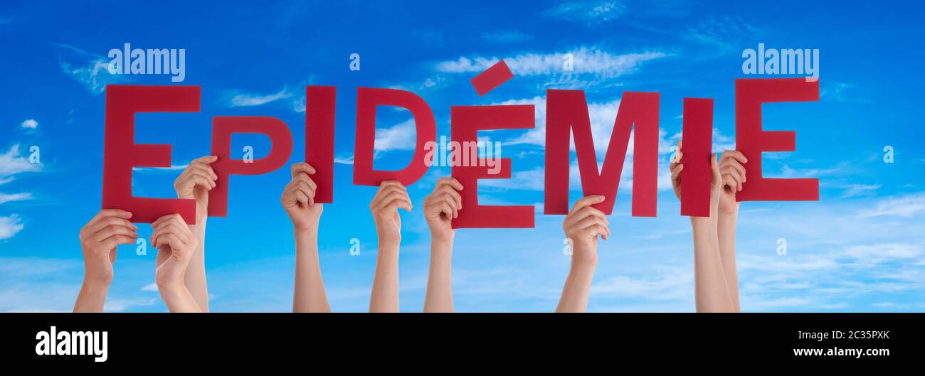People Hands Holding Colorful French Word Epidemie Means Epidemic. Blue Sky As Background Stock Photo