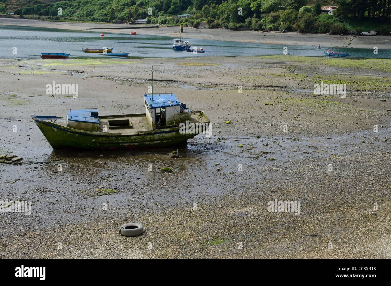 Fishing boat stranded in the coast. Angelmo. Puerto Montt. Los Lagos Region. Chile. Stock Photo