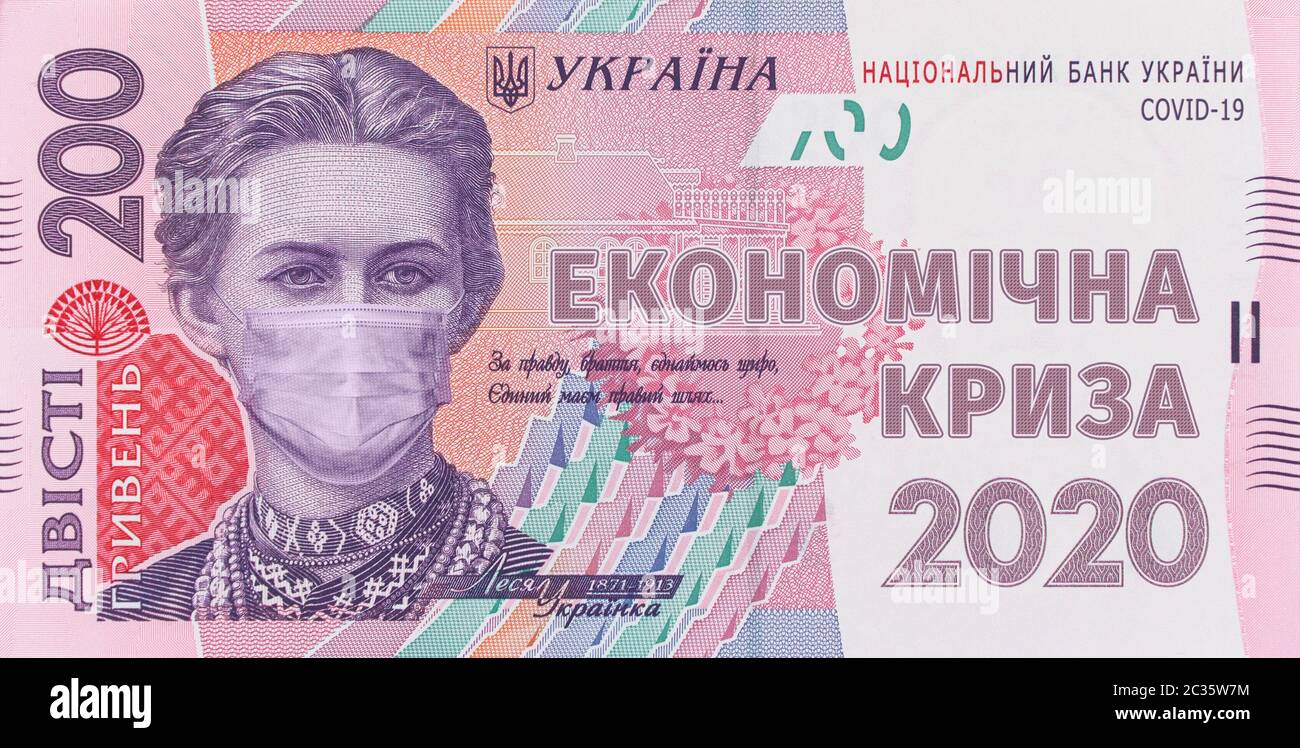 200 hryvnia banknote with Lesya Ukrainka in a medical mask with the inscription - ECONOMIC CRISIS 2020. Economic crisis has affected Ukraine, concept. Stock Photo