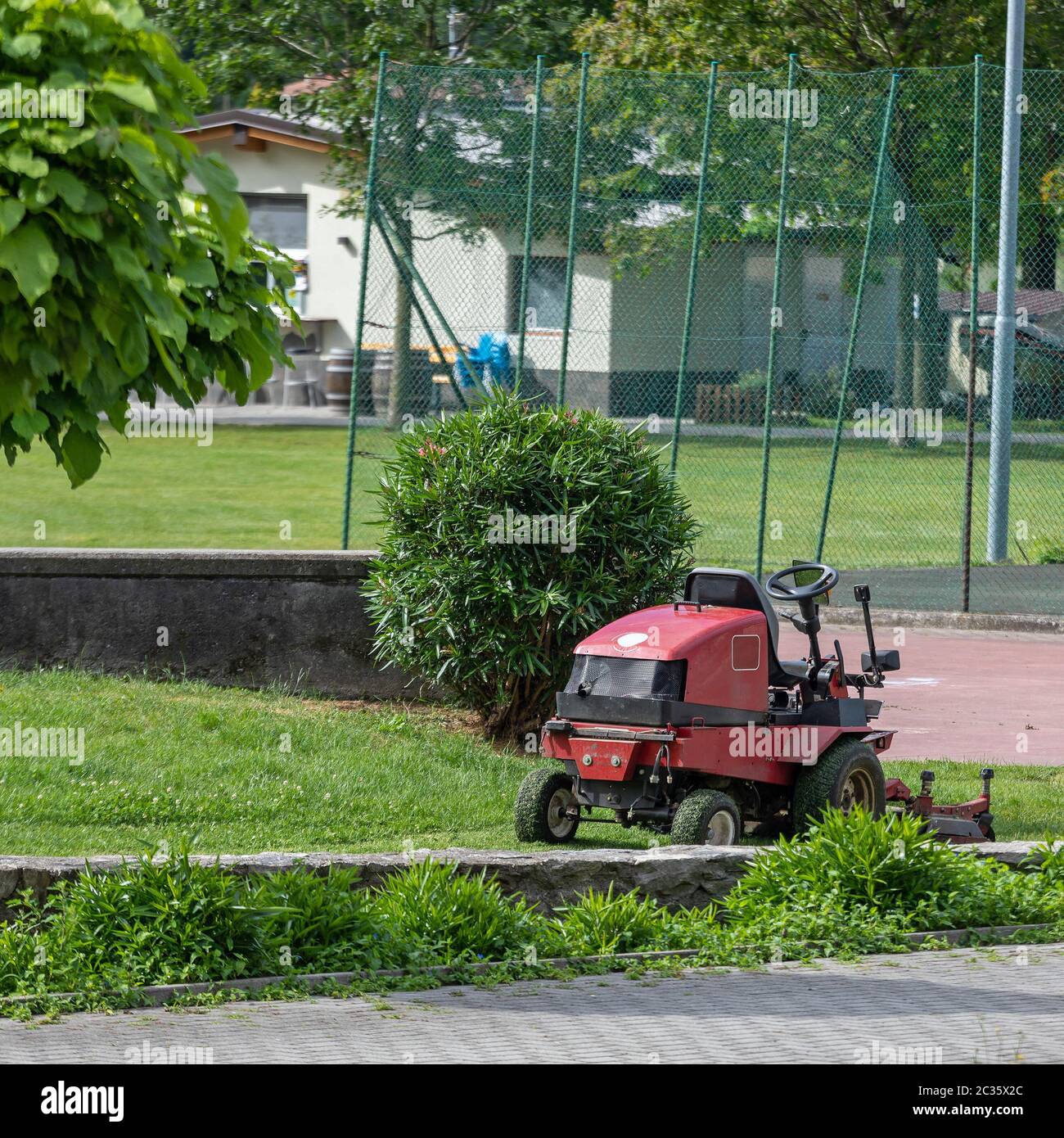 Ride on Lawn Mower Machine in Park Stock Photo