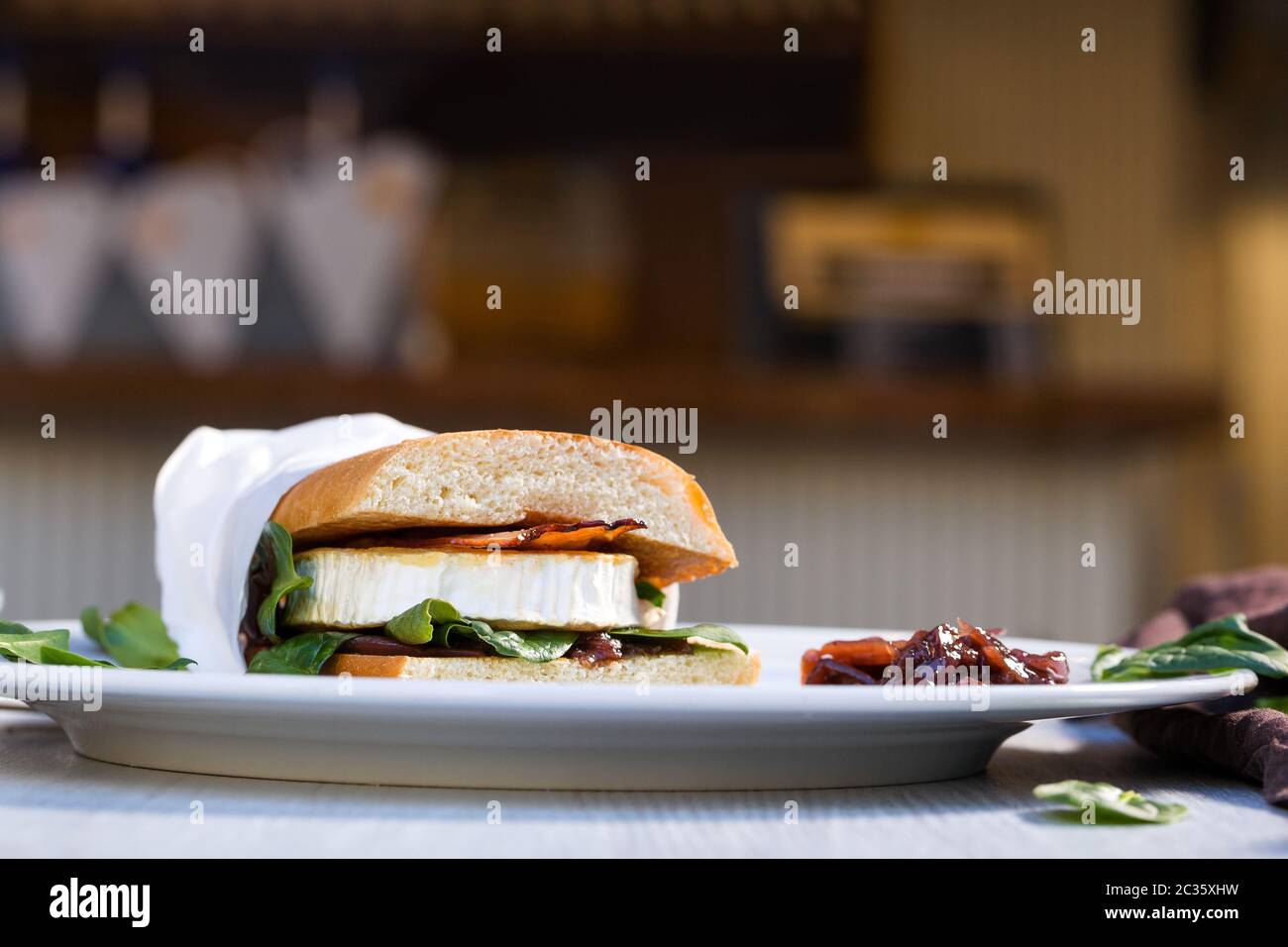 Sandwich with fresh goat cheese, bacon and spinach. Gourmet street food