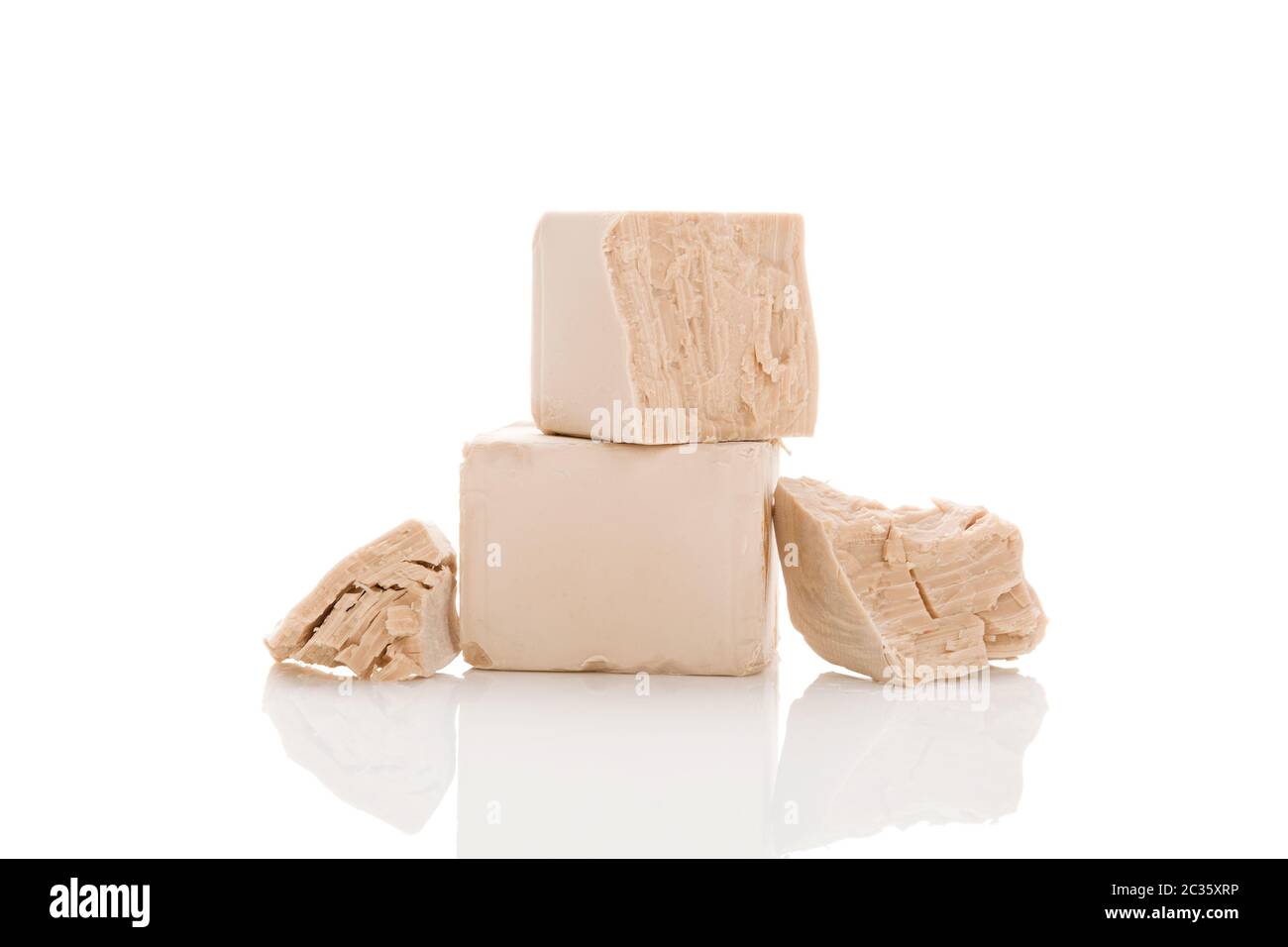 Fresh pressed yeast blocks isolated on white background. Stock Photo