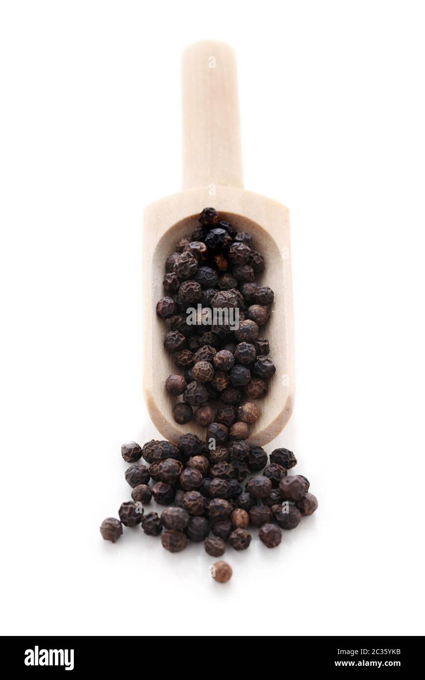 Black Peppercorns In A Wooden Shovel Isolated On White Stock Photo