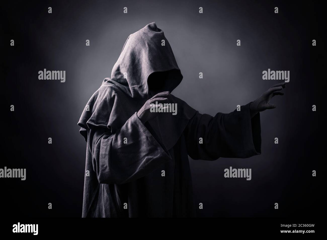 Scary figure in hooded cloak Stock Photo