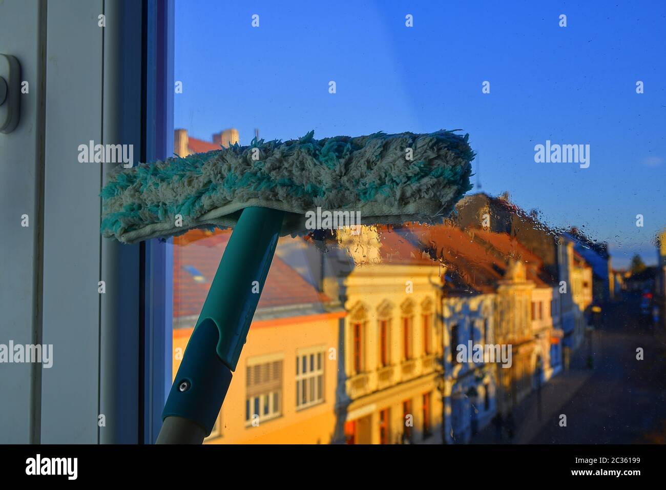 Cleaning windows with a squeegee. Cleaning concept. Washing window