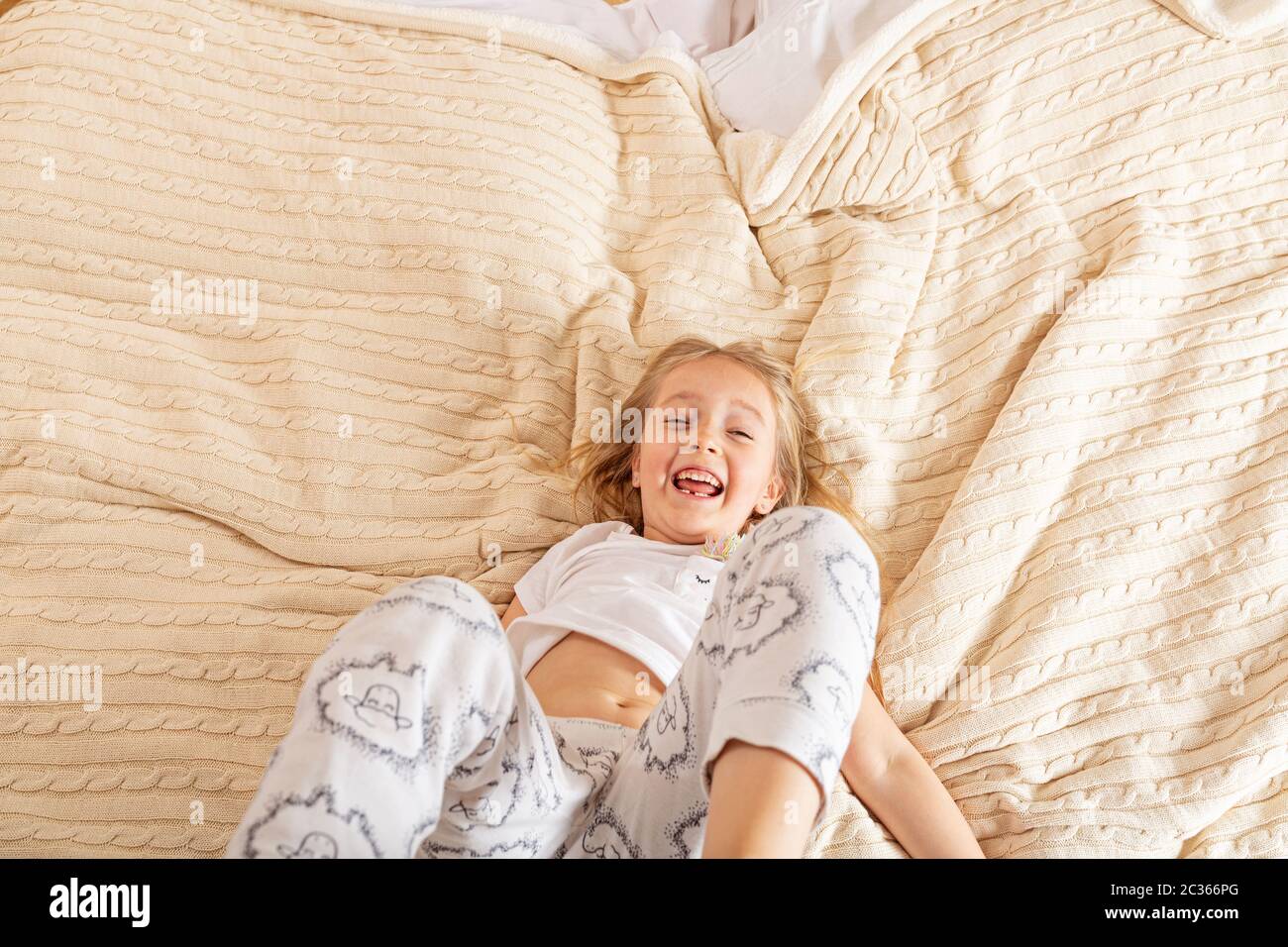 Beautiful little girl in pajamas jumping on the bed at home. Stay at home during coronavirus covid 19 lockdown and have a fun. Happy childhood concept Stock Photo Alamy