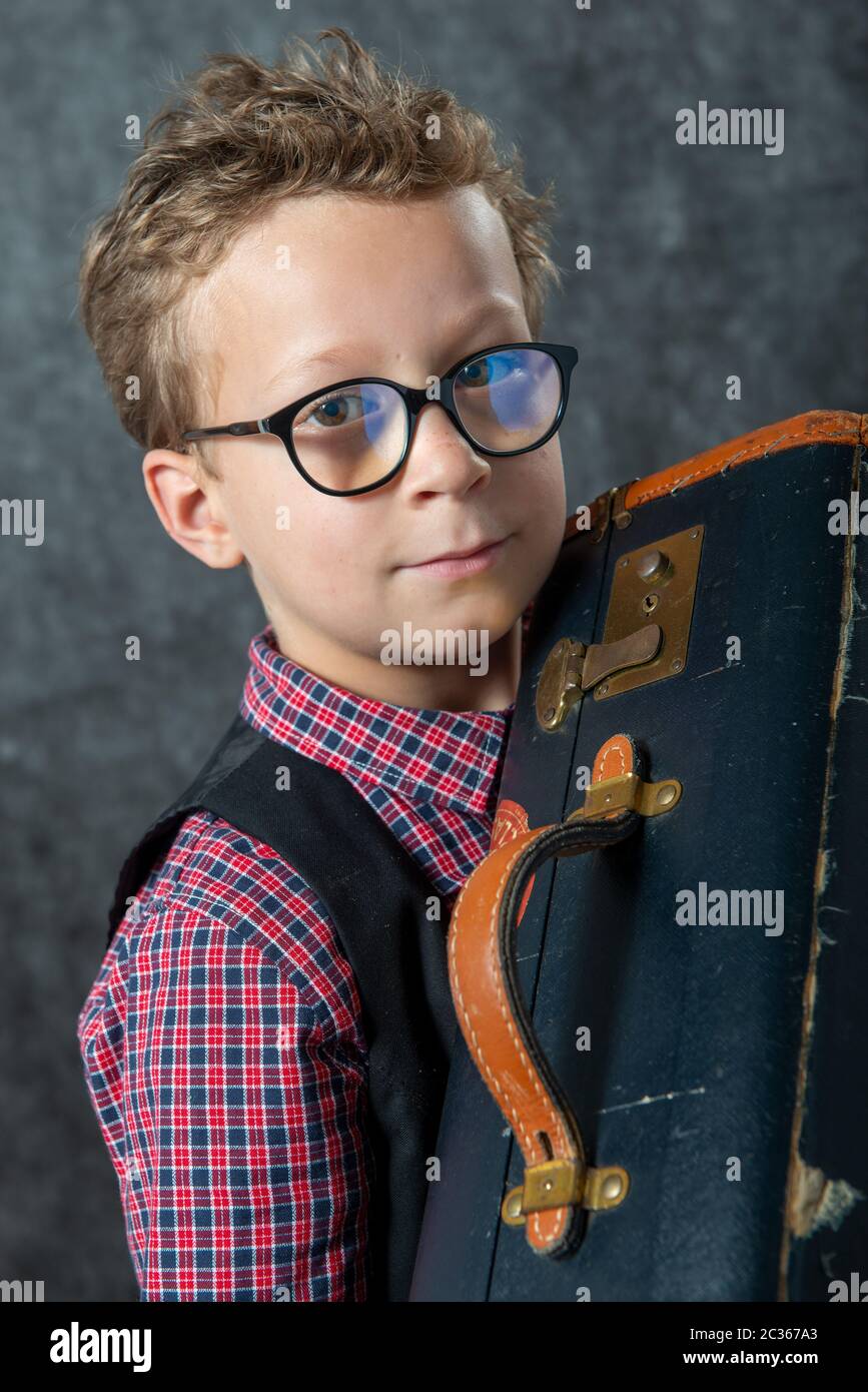 a young boy with a suitcase Stock Photo