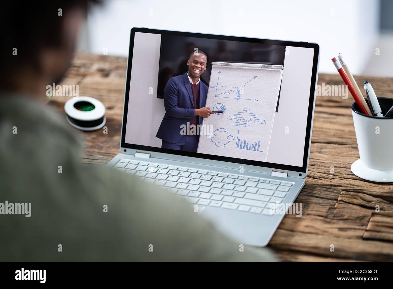 Man Participating In Online Coaching Session Using Laptop Stock Photo