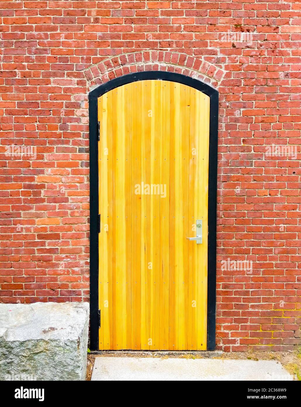 Oldfashioned Plank Door in Brick Wall Stock Photo Alamy