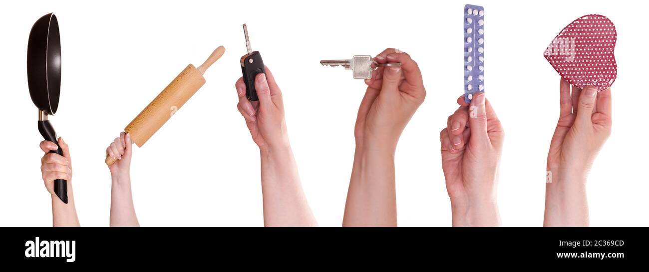 Hände einer Frau weiß freigestellt mit Pfanne, Nudelholz, Schlüssel, Tabletten, Autoschlüssel und Herz Stock Photo