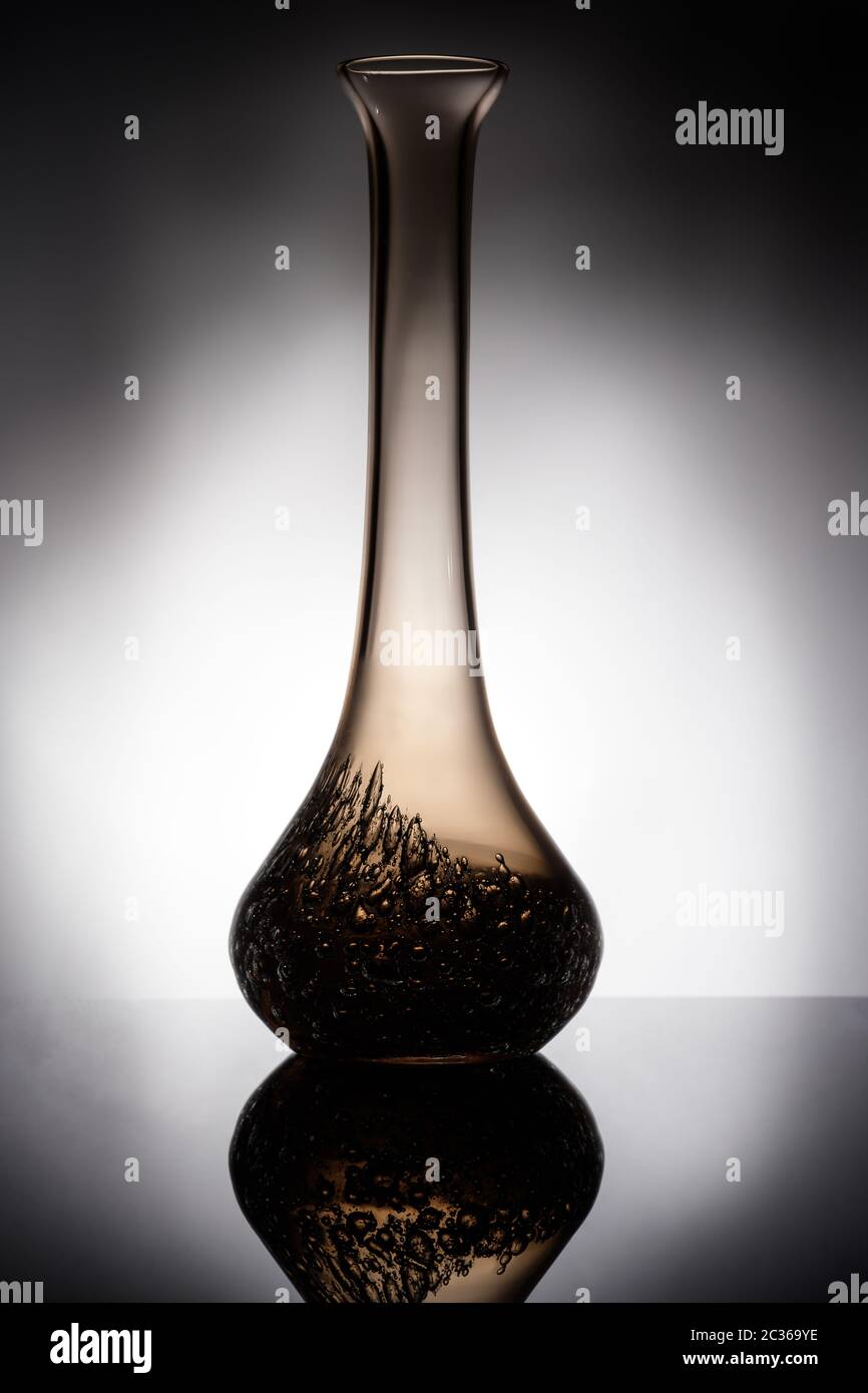 Glass vase in backlight with reflection in vertical format Stock Photo