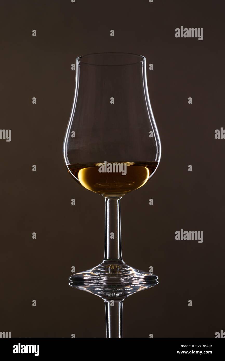 Glass with scottisch Whisky und reflection with black background Stock Photo