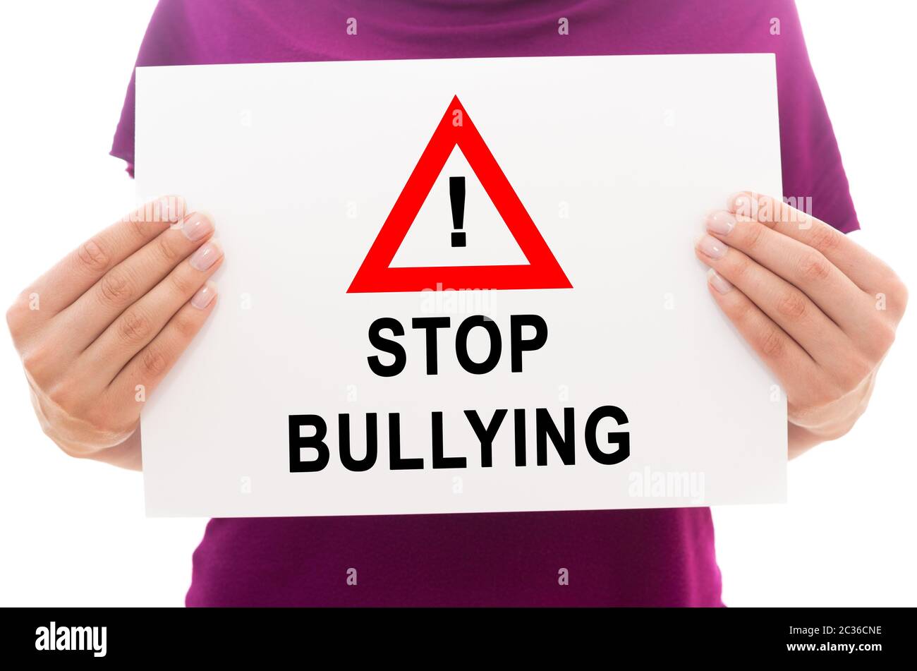 Girl holding white paper sheet with text Stop bullying Stock Photo